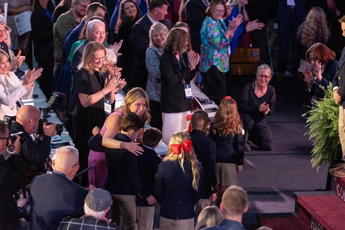 woman giving children a hug